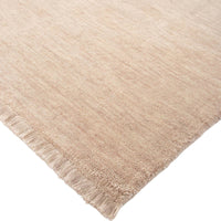 Beige rug with fringes on a white background