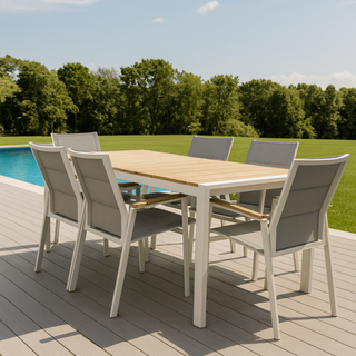 Outdoor dining table with six dining chairs around it next to a pool