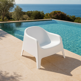 White tub chair next to a pool