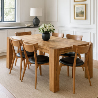 Oak dining table with six chairs placed around it