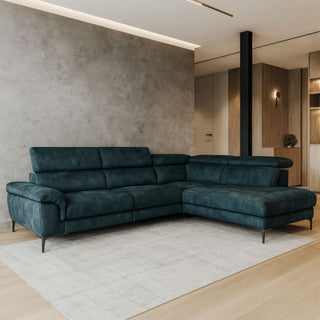 modern teal velvet lounge suite in a room with a concrete wall.