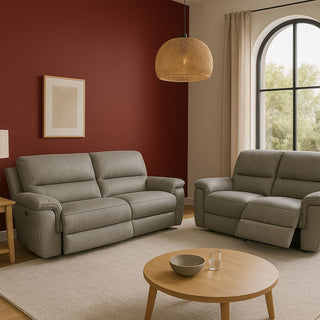 Grey reclining lounge suite in a room with a red wall and a rattan lampshade