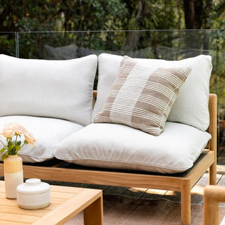 Outdoor cushion on a teak outdoor sofa