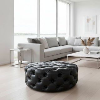 black buttoned ottoman with modern white furniture