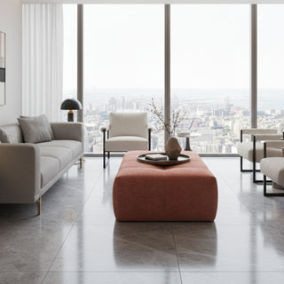 Pink ottoman in a modern room with lots of white furniture