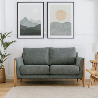 Green sofa with oak arms in a scandinavian styled room