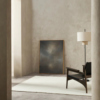Modern interior with a painting, chair, and lamp on a neutral background