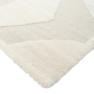 Close-up of a textured white rug corner on a white background