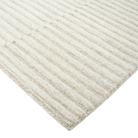 Close-up of a textured beige rug with a white background