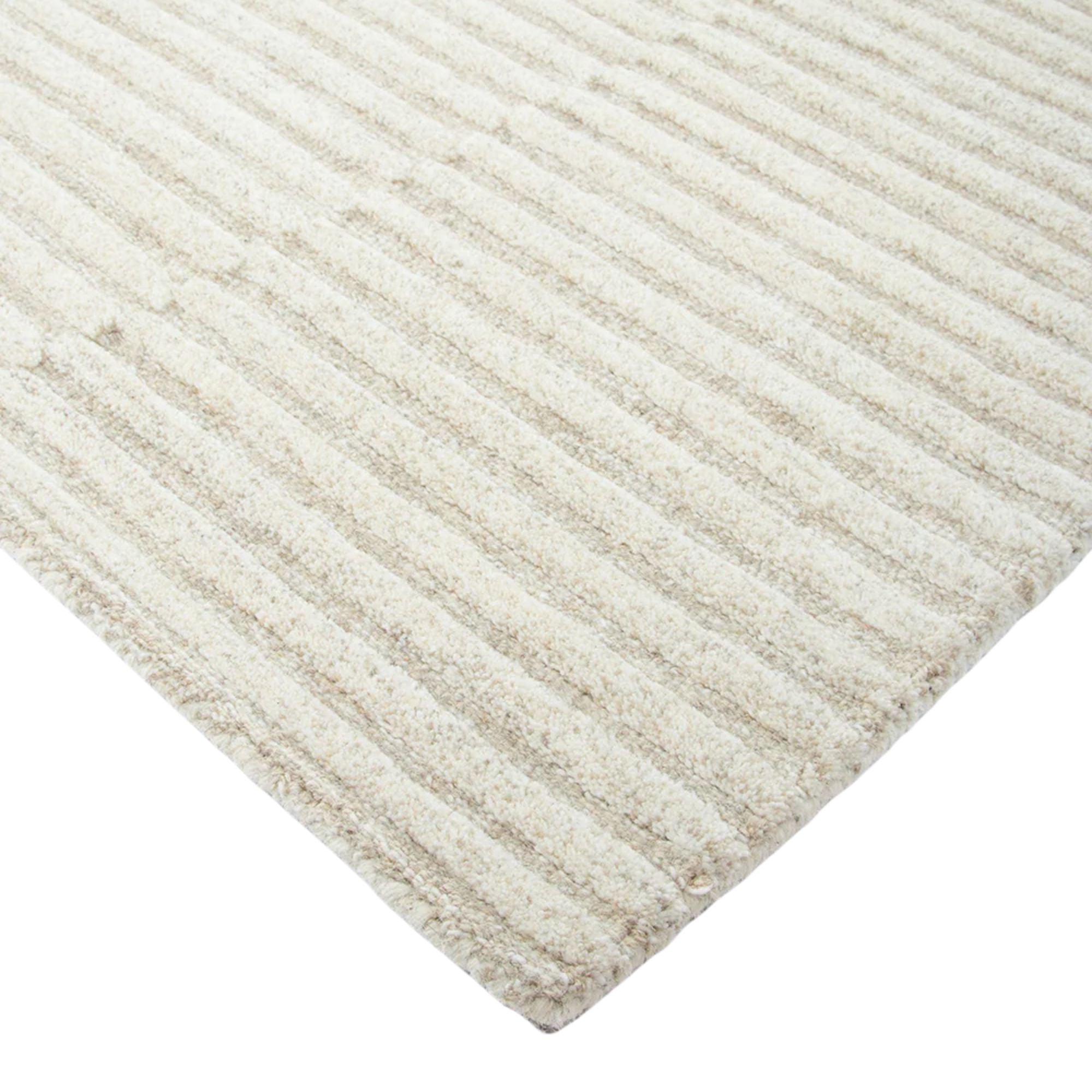 Close-up of a textured beige rug with a white background