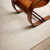 Wooden chair on a textured beige carpet