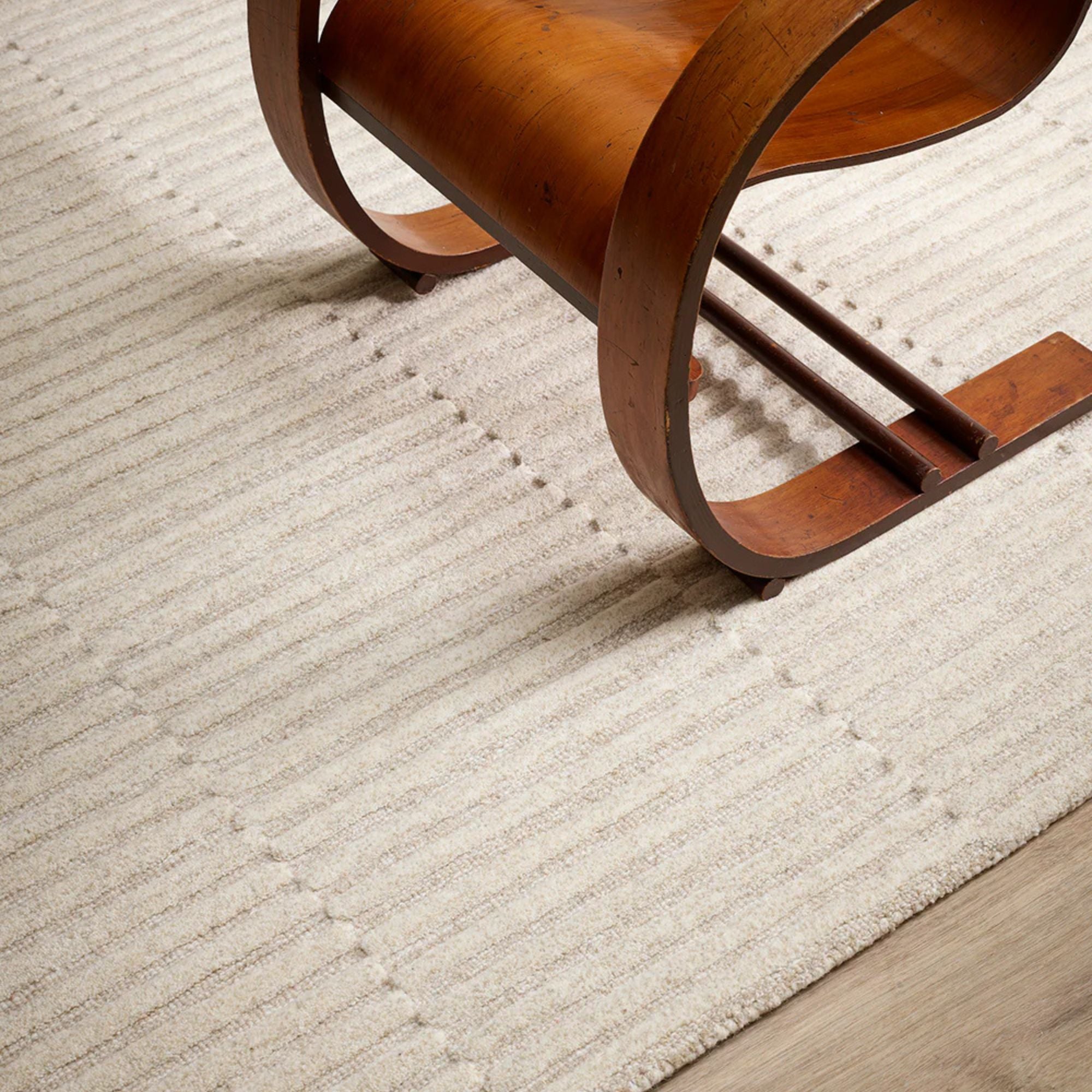Wooden chair on a textured beige carpet