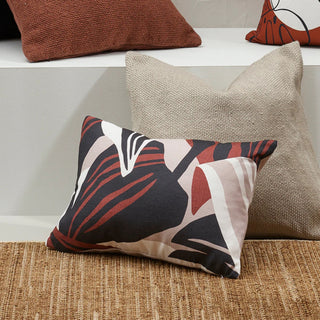 Decorative pillows on a textured surface with a neutral background