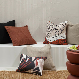 Decorative pillows on a shelf with a neutral background