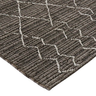 Close-up of a textured brown and beige area rug with geometric pattern