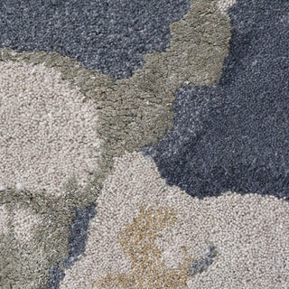 Close-up of a textured rug with a camouflage pattern in shades of gray, beige, and blue.