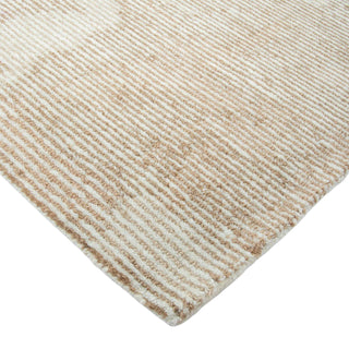 Close-up of a textured beige and white rug corner