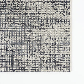 Textured black and white patterned rug on a plain background