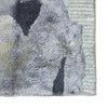 Textured rug with a mix of gray, black, and beige colors on a white background