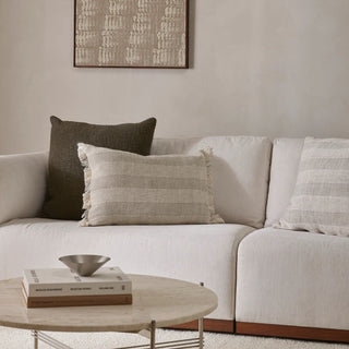 White sofa with patterned cushions in a living room setting