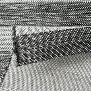 Close-up of woven rug with a geometric pattern