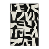 Black and white abstract patterned rug on a plain background