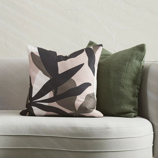 Decorative pillows on a sofa with a neutral background