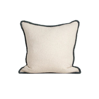 Beige pillow with black trim on a white background