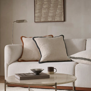 White sofa with decorative pillows and a coffee table in a living room setting.