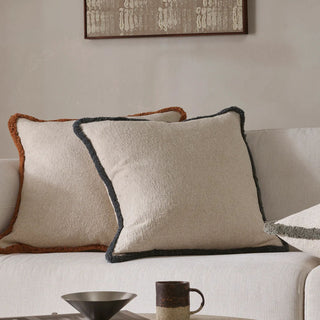 Decorative pillows on a sofa with a neutral color scheme