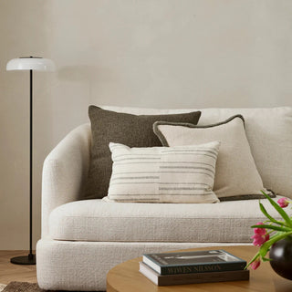 Beige sofa with decorative pillows in a living room setting