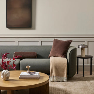 Living room with a gray sofa, wooden coffee table, and decorative items.