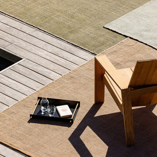Wooden chair and table on a textured outdoor floor