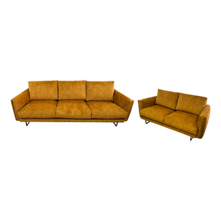 Two mustard yellow sofas on a white background