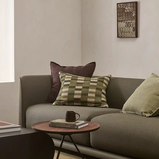 Gray sofa with decorative pillows in a living room setting