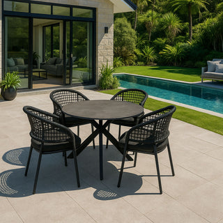 Outdoor patio set with table and chairs by a pool