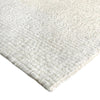 Close-up of a textured white rug corner