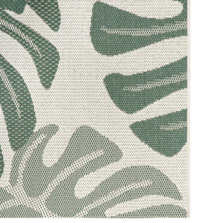 Close-up of a green leaf pattern on a textured surface