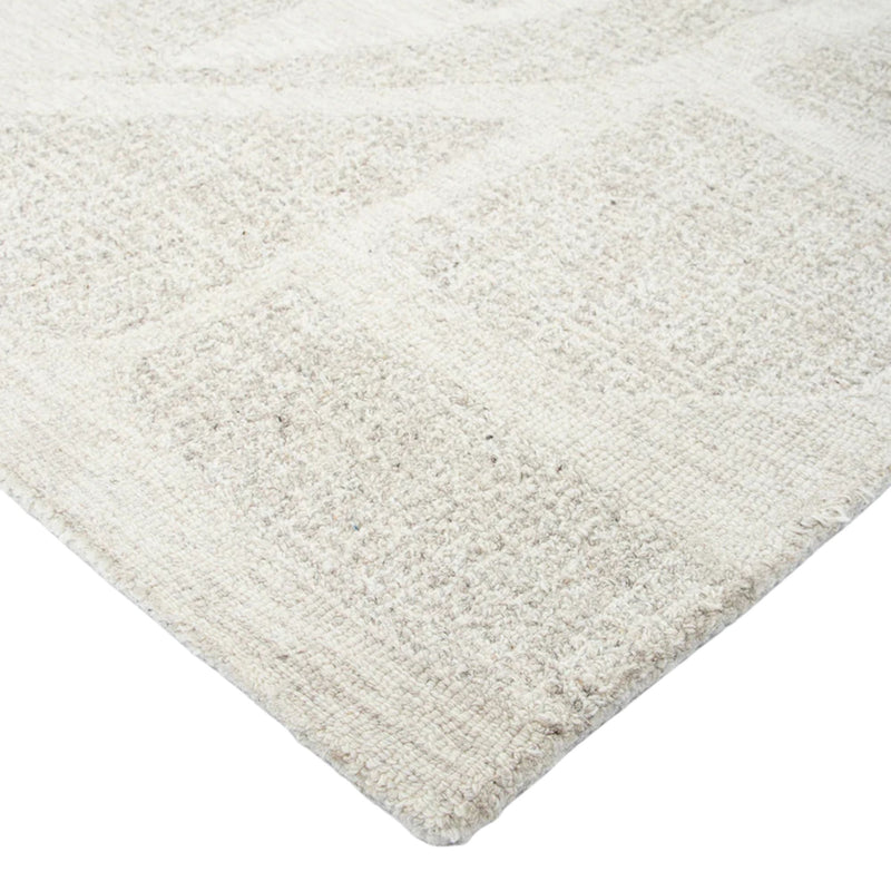 Close-up of a textured beige rug on a white background