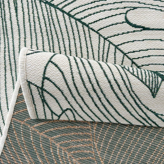 Close-up of a textured rug with leaf pattern and rolled edge