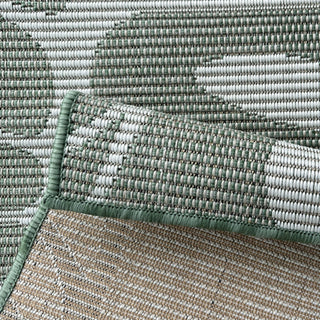 Close-up of a textured green and beige rug corner