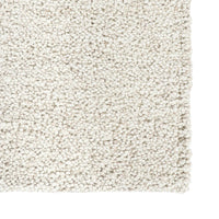 Close-up of a textured beige carpet sample