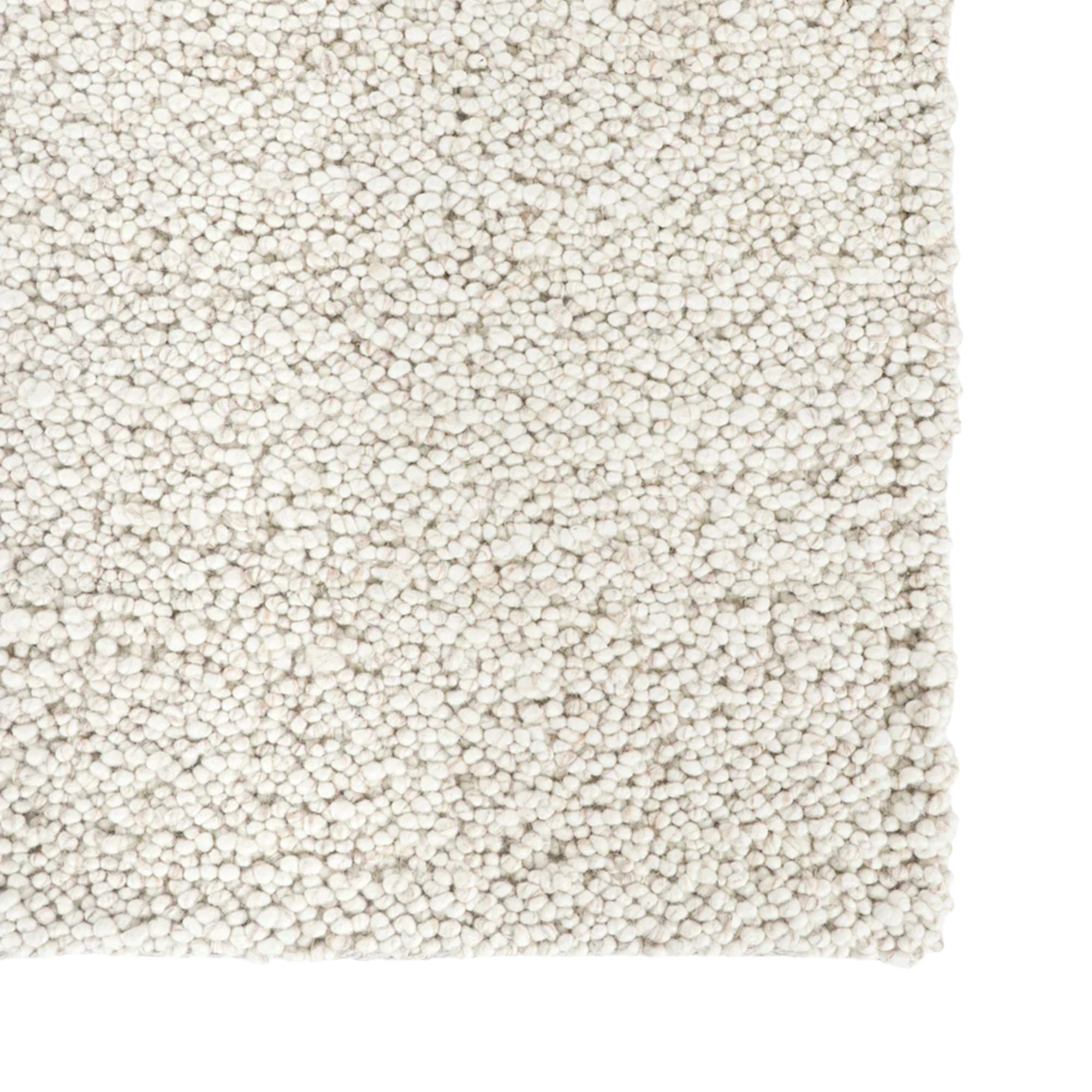 Close-up of a textured beige carpet sample