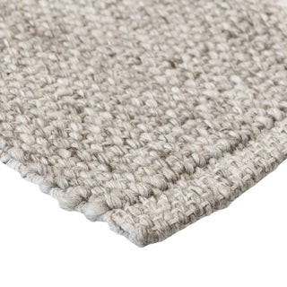 Close-up of a textured beige rug on a white background