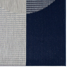 Close-up of a fabric with a checkered pattern transitioning from gray to navy.