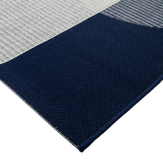 Navy and gray checkered rug on a white background