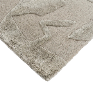 Close-up of a textured beige rug with geometric pattern on a white background