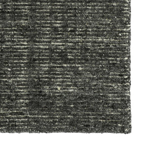 Textured black and gray rug corner
