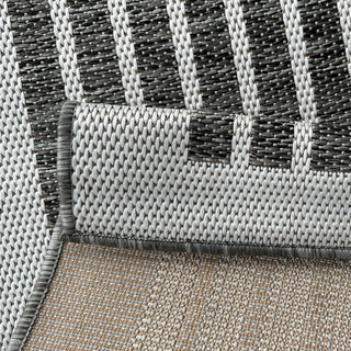 Close-up of a textured rug with a geometric pattern