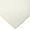 Close-up of a textured white rug corner on a white background